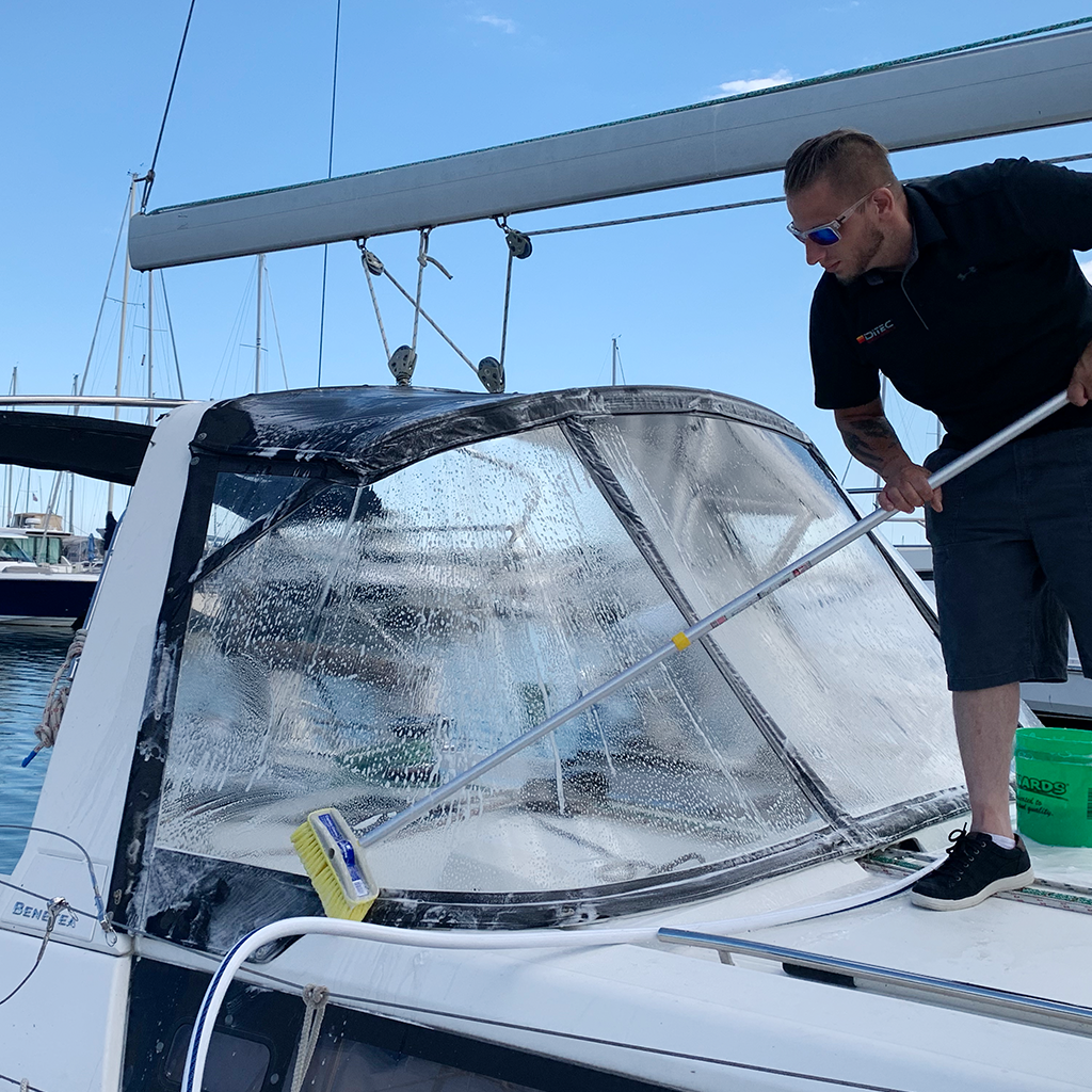 man washing boat with boat soap from ditec