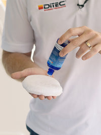 Man applying glasstec marine glass protectant to sponge.
