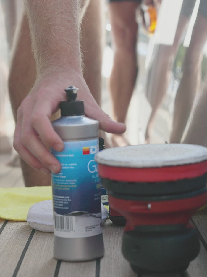 Man applying ditec's G200 marine glass polish and cleaner to polishing pad
