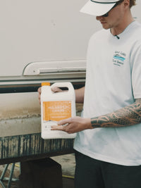 Man showing Hull & Bottom Cleaner from DiTEC in use on boat in a harbor