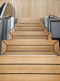 Teak boat deck stairs after being cleaned by Teak Magic non-toxic gel teak cleaner from DiTEC
