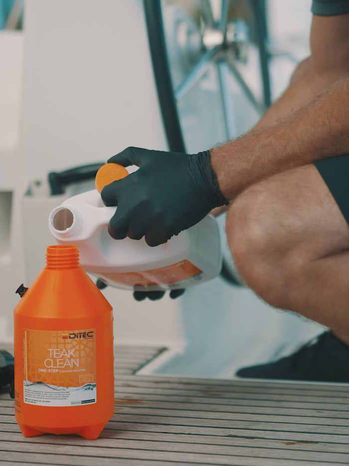 man applying eco friendly teak cleaner from ditech to boat's deck
