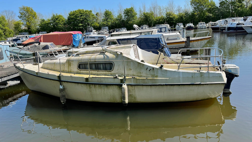 Sailboat covered in algae and mildew