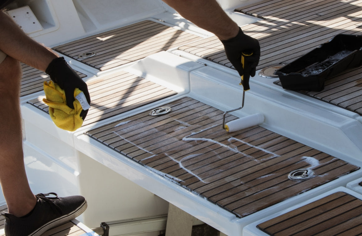 Man applying Triton 2.0 on teak boat deck