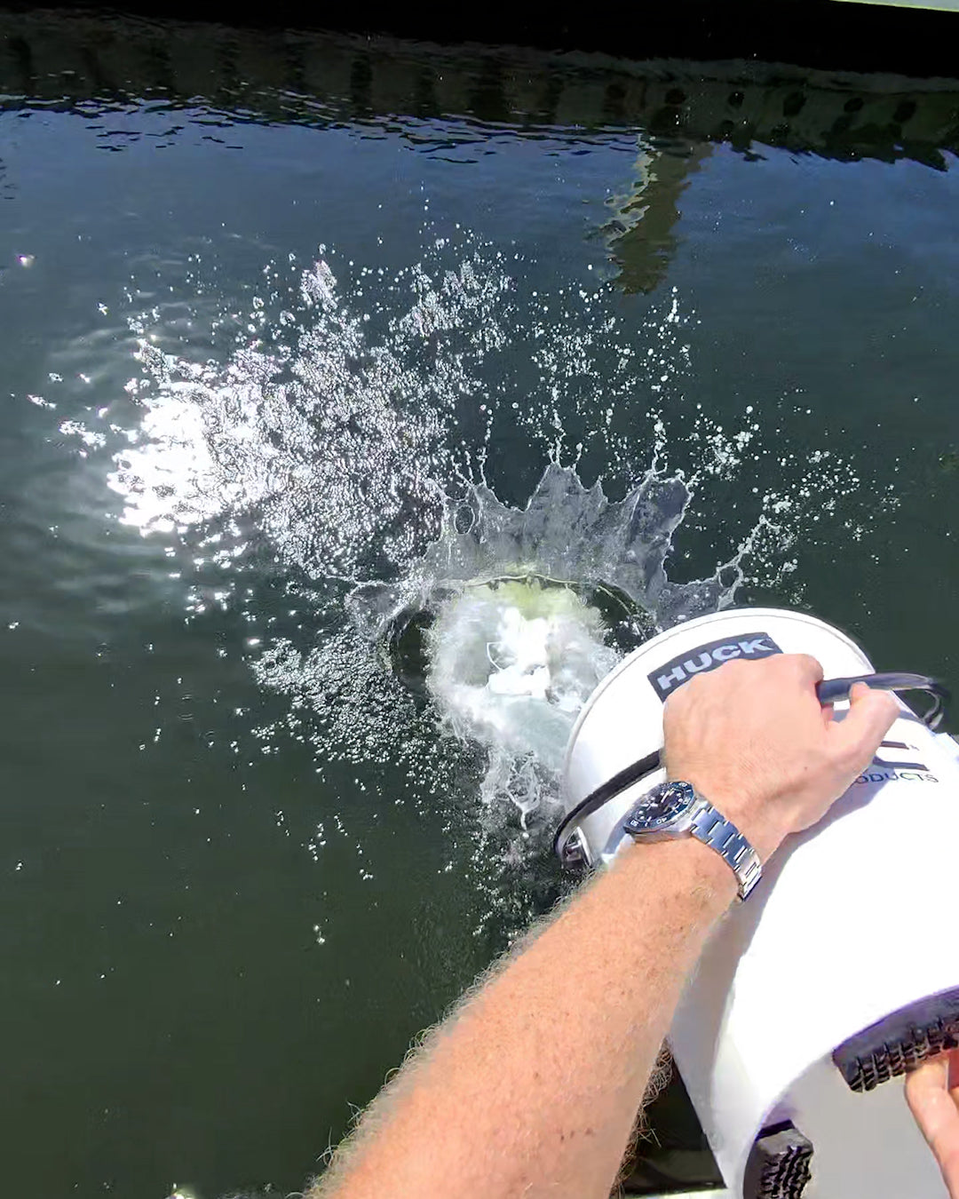 Rinsing DiTEC Elite Boat Wash biodegradable cleaner into waterways
