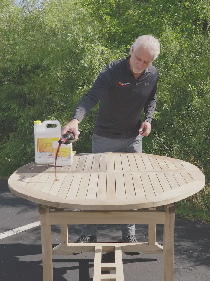 Man showing results from using DiTEC teak furniture restoration kit's Triton 2.0 teak sealant on an outdoor teak table.
