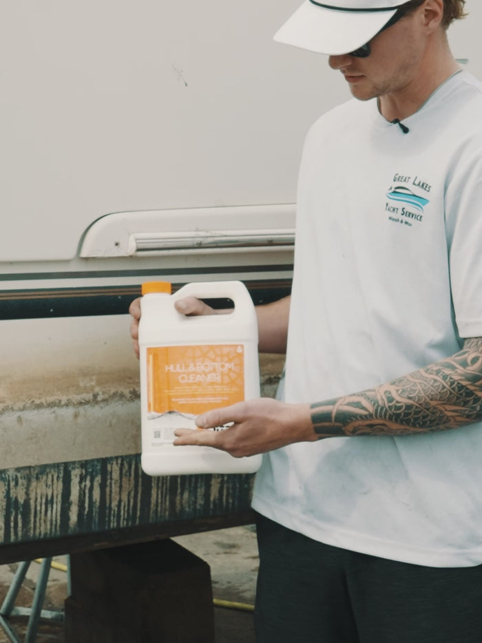 Man showing Hull & Bottom Cleaner from DiTEC in use on boat in a harbor