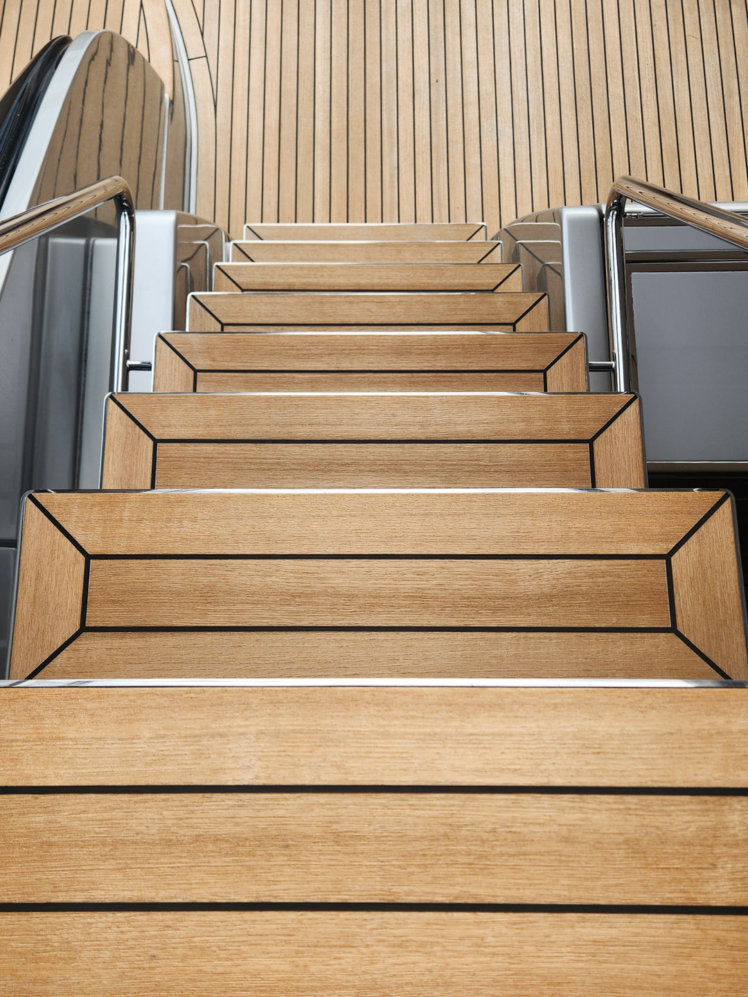 Golden teak stairs and deck panels on a yacht, cleaned and bright with no grey weathering