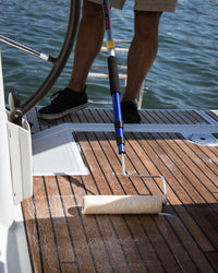 man applying ditec teak protectant TRITON on boat deck